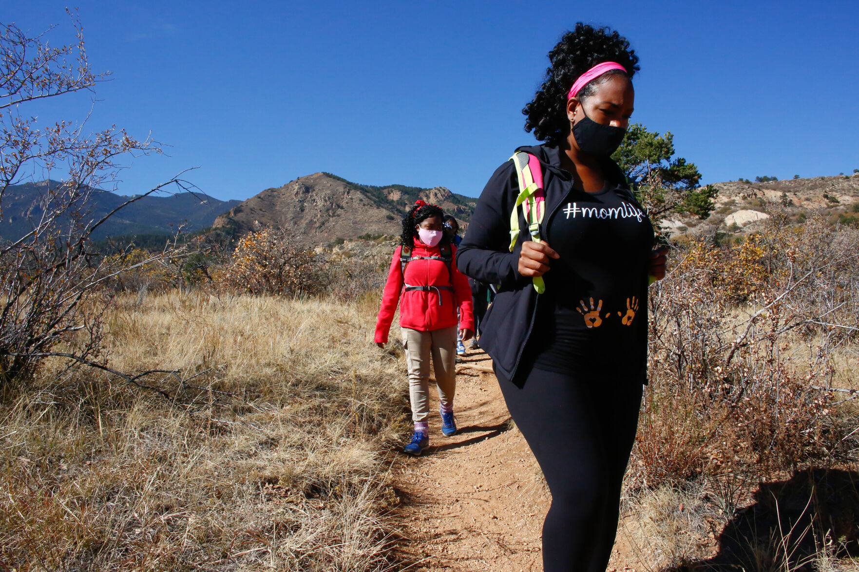 Jessica Newton, right, and her 14- year-old daughter, Joy Eloi, hike through Bear Creek Regional Park in Colorado Springs, Colorado, on Oct. 24, 2020.